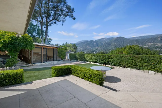a view of a garden with mountains in the background