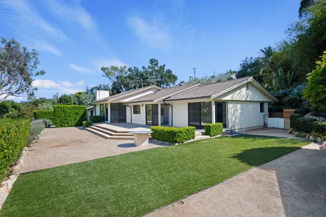 a front view of house with yard and green space