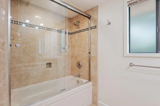 a bathroom with a bathtub and a shower