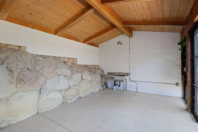 a view of a patio area with table and chairs