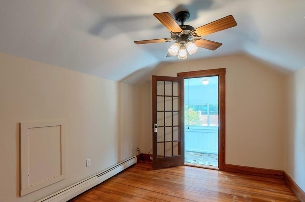 142 East Meadow Road Lowell, MA 01854 - Photo 21 of 28 an empty room with wooden floor chandelier fan and windows