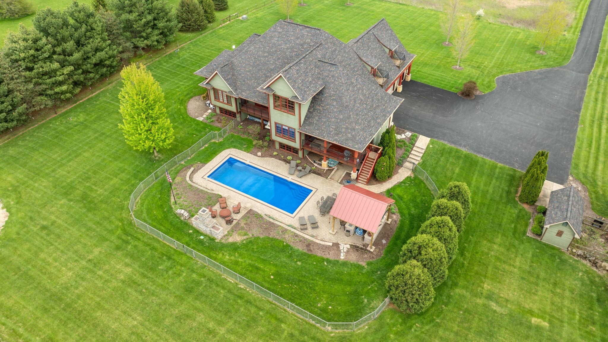 an aerial view of a house with a garden and trees