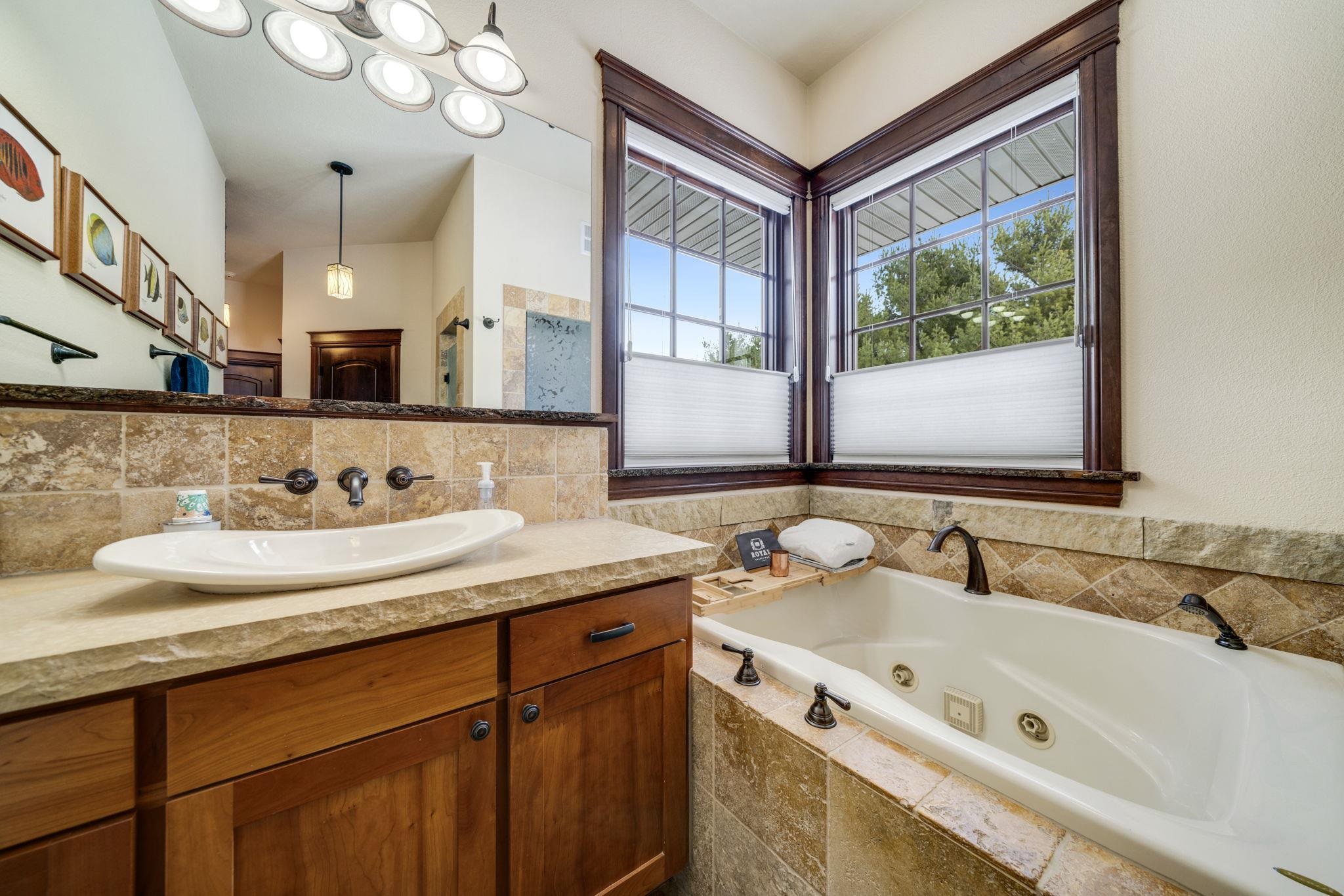 6871 Montague Road Rockford, IL 61102 - Photo 19 of 77 a bathroom with a tub sink and mirror