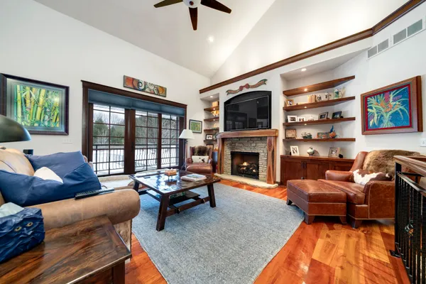 a living room with couches and a flat screen tv