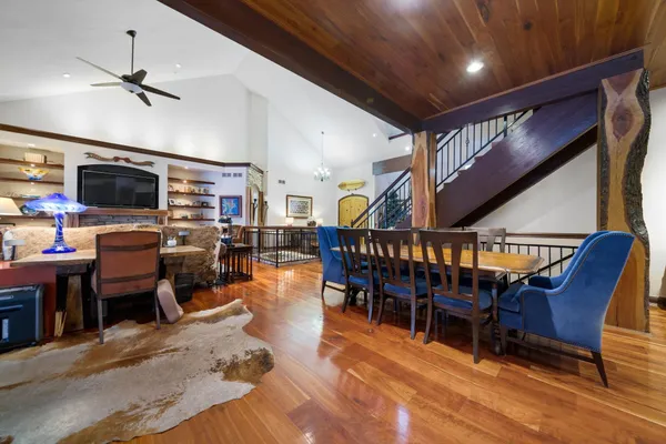 a big room with wooden floor and windows
