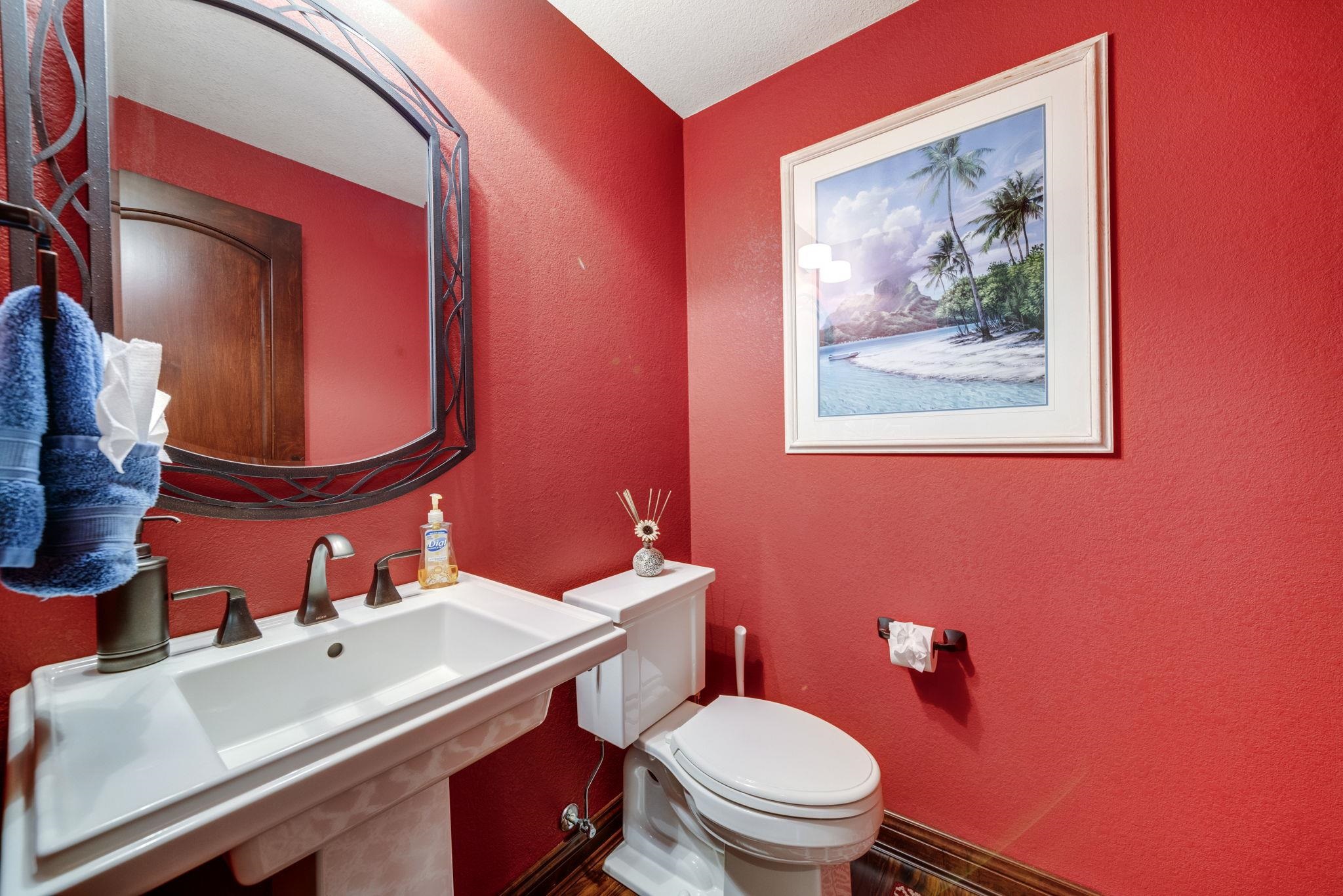 6871 Montague Road Rockford, IL 61102 - Photo 64 of 77 a bathroom with a toilet a sink and mirror