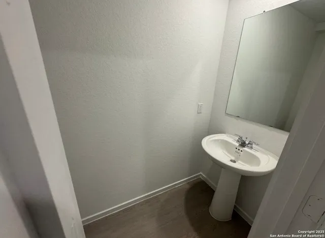 a bathroom with a sink a mirror and a sink