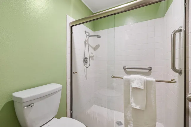 a white toilet sitting next to a bathroom