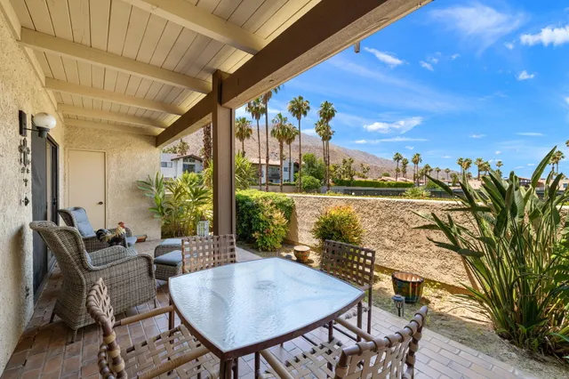 a view of swimming pool with outdoor seating and plants
