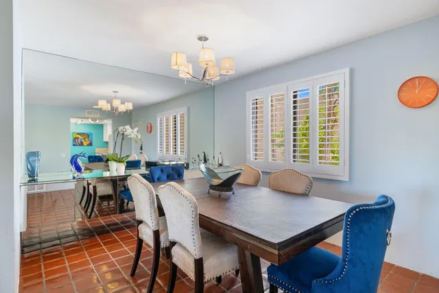 a view of a dining room with furniture and chandelier