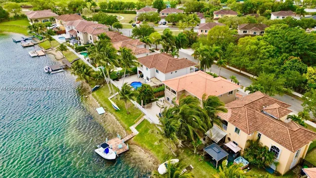 an aerial view of residential house with yard and swimming pool