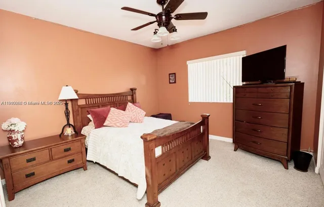 a bedroom with a bed and ceiling fan