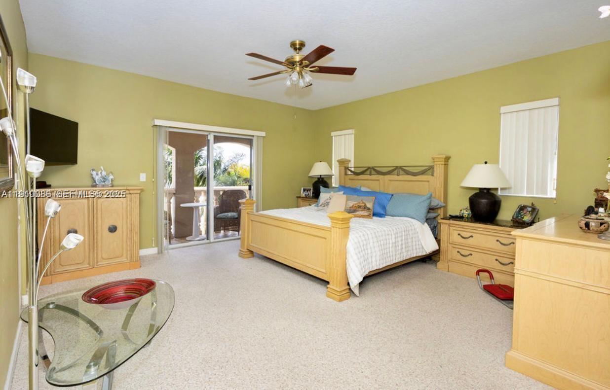 14241 Southwest 129th Avenue Miami, FL 33186 - Photo 14 of 24 a bedroom with a bed and ceiling fan