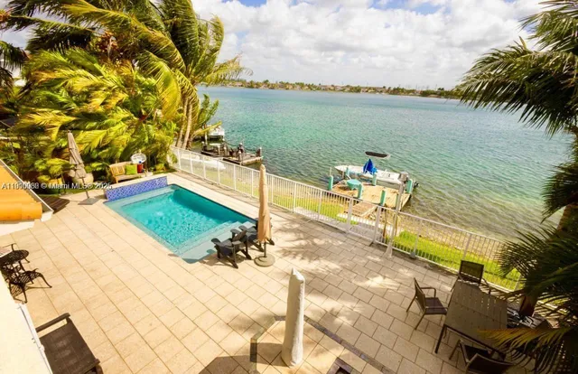 a view of a lake with couches in patio