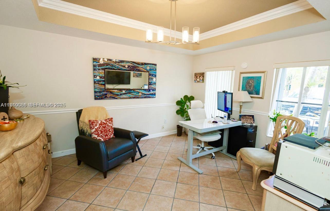 14241 Southwest 129th Avenue Miami, FL 33186 - Photo 10 of 24 a living room with furniture and a flat screen tv