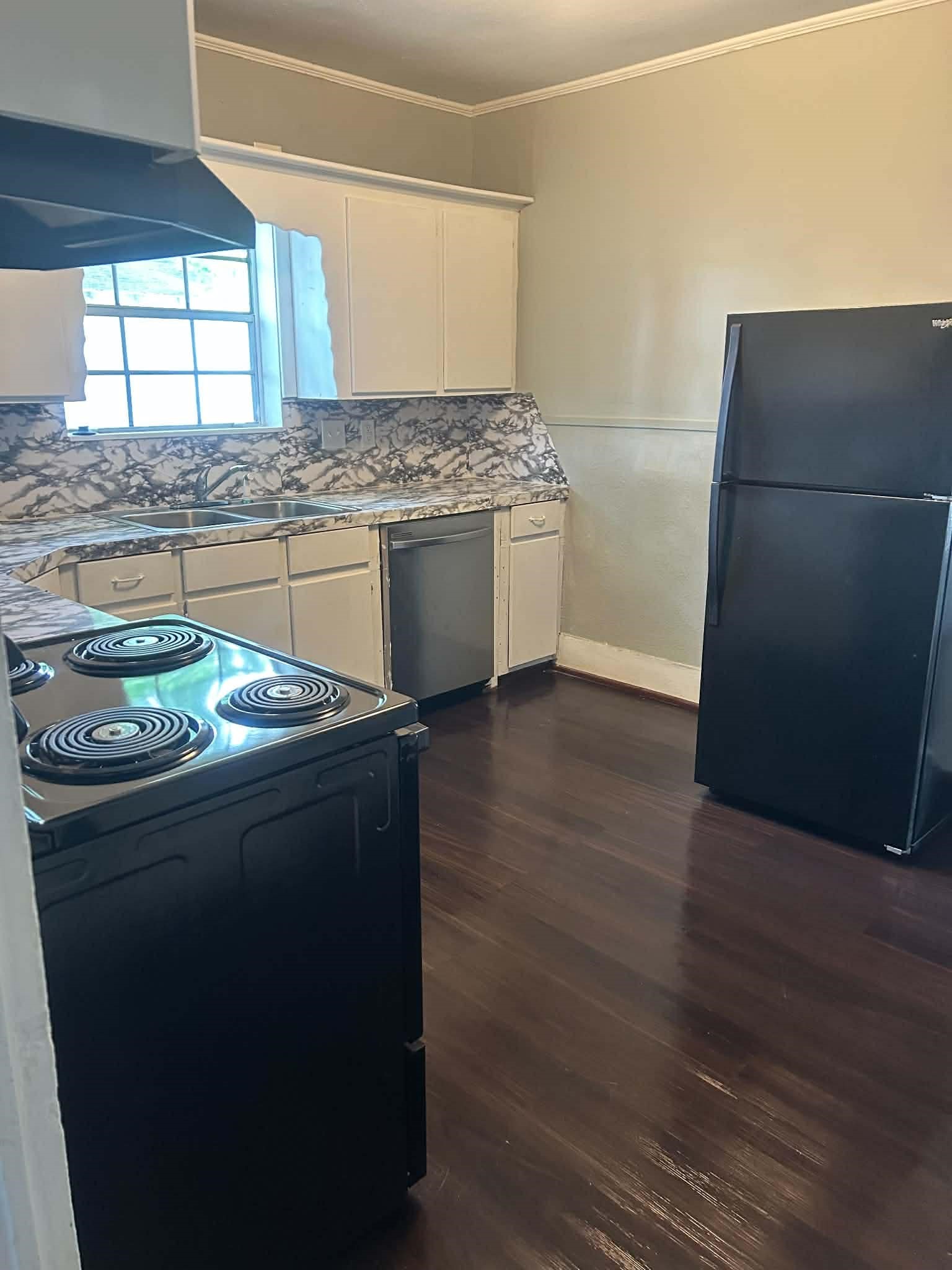 11 Smith Street Shepherd, TX 77371 - Photo 20 of 31 a kitchen with granite countertop a refrigerator a stove a sink and a window