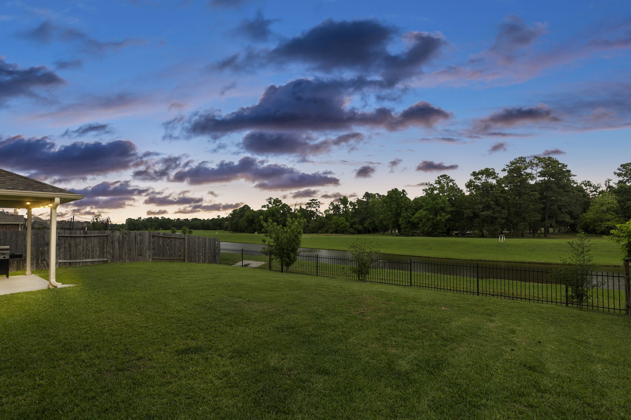 22810 Dale River Road Tomball, TX 77375 - Photo 35 of 44 Rain or shine, sunrise or sunset, this backyard was designed for relaxing and perfect for entertaining.