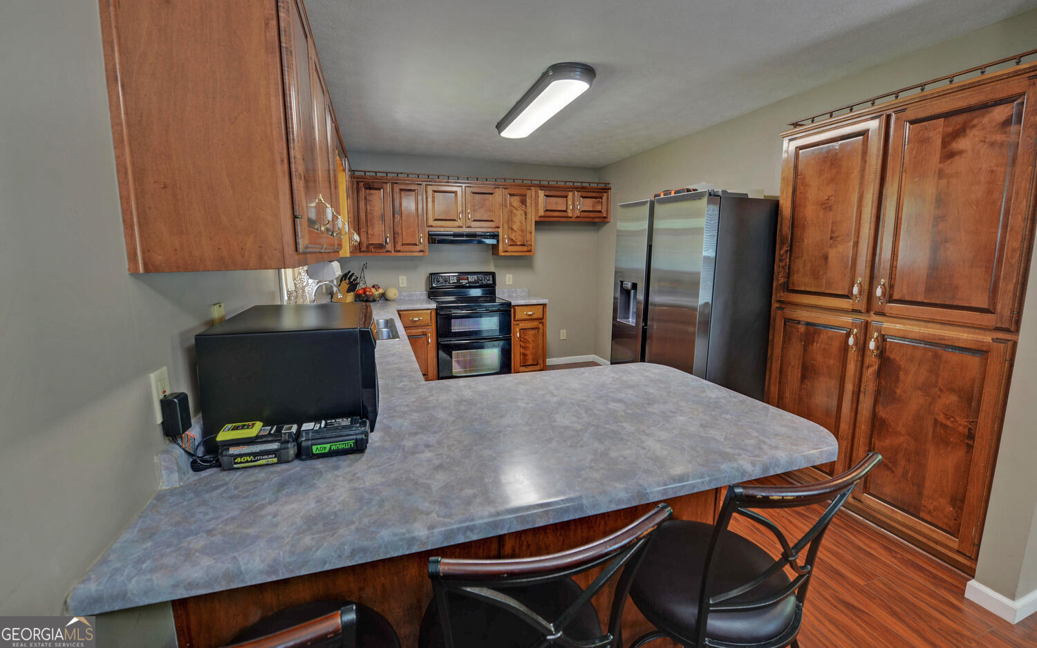 46 Cedar Ridge Drive Toccoa, GA 30577 - Photo 14 of 48 a kitchen with stainless steel appliances a refrigerator a stove a sink a dining table and chairs
