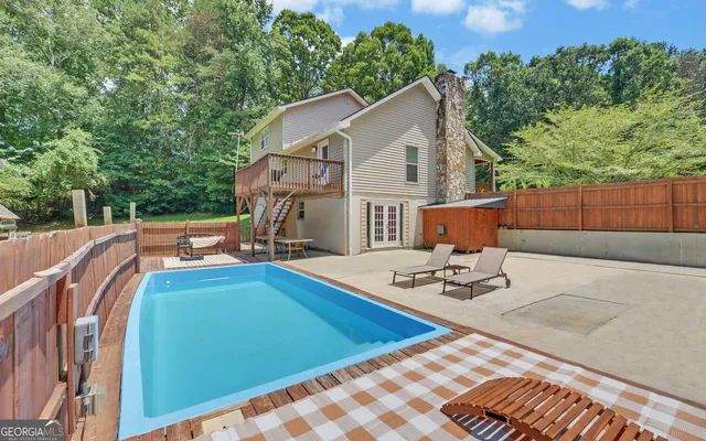 a view of a patio with chairs and potted plants