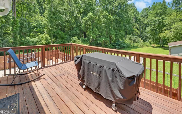 a view of balcony with wooden floor and outdoor seating