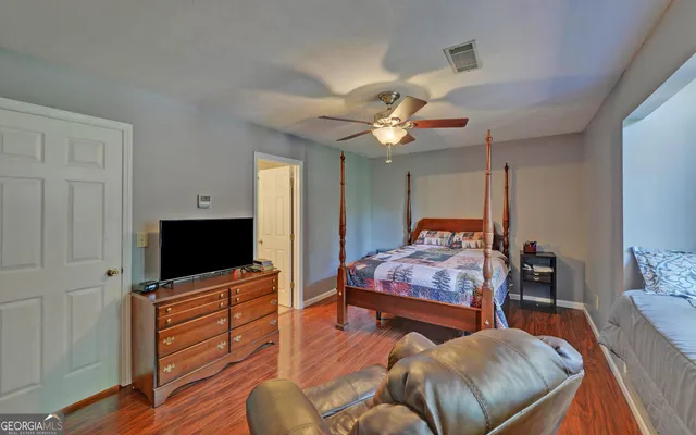 a bedroom with furniture and a flat screen tv