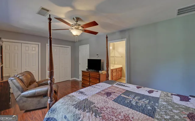 a bedroom with a bed couch and a window