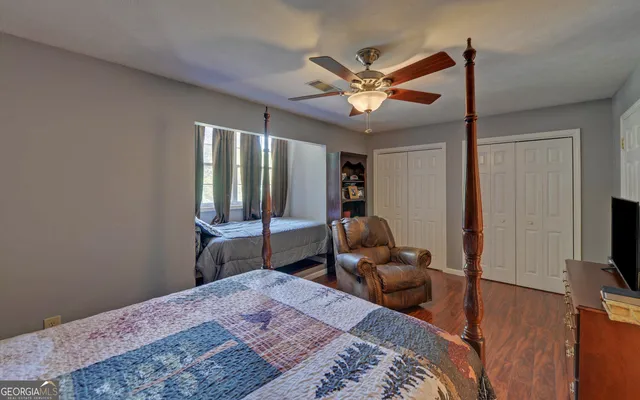 a bedroom with a bed and wooden floor