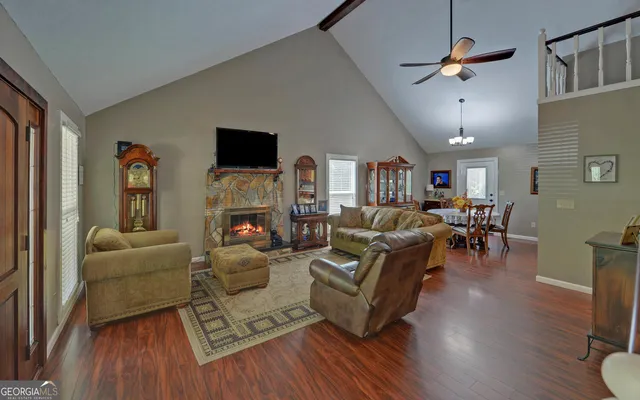 a living room with furniture wooden floor and a fireplace