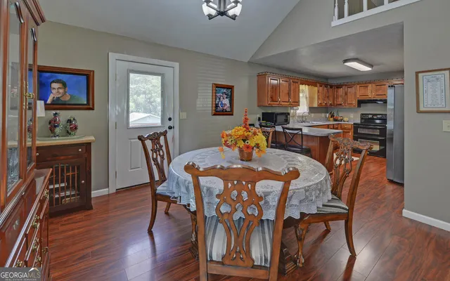 a dining room with furniture and wooden floor