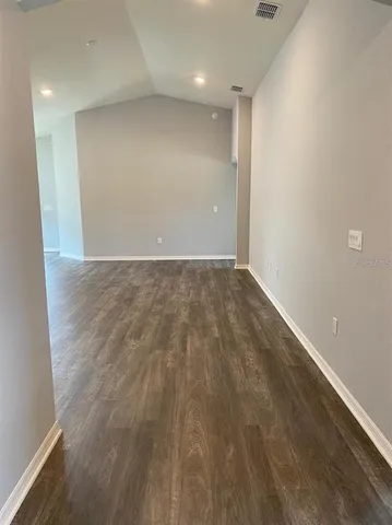 an empty room with wooden floor