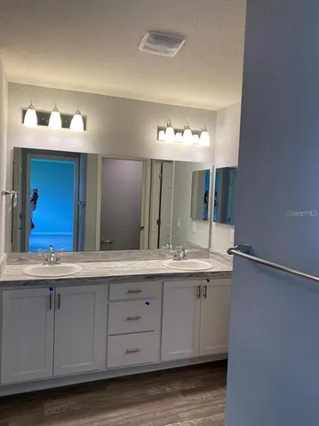 a bathroom with a granite countertop sink a shower and a mirror