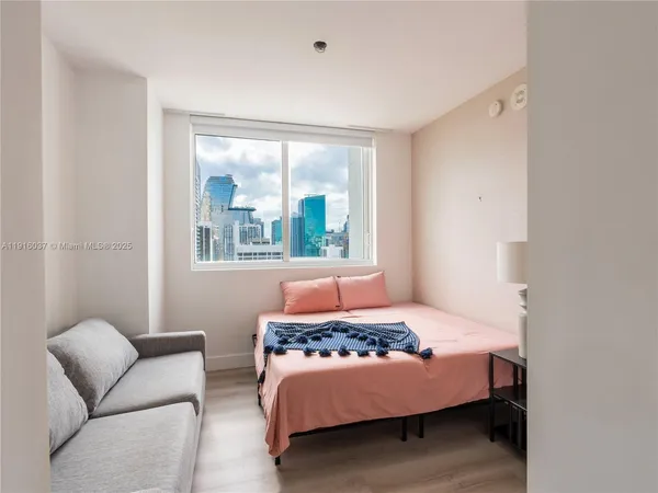a bedroom with a bed and a couch