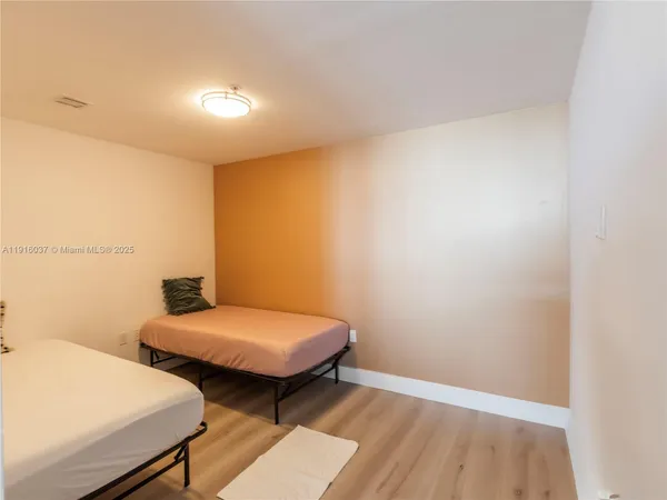 a bedroom with two beds and a table