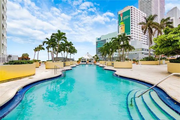 a view of swimming pool with a table and chairs