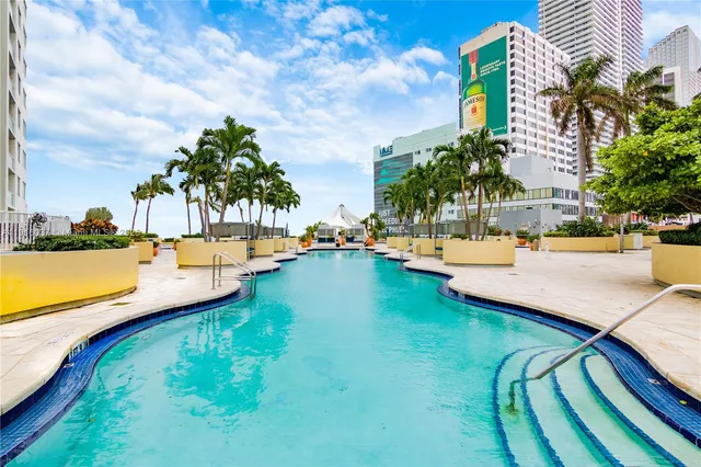 a view of swimming pool with a table and chairs