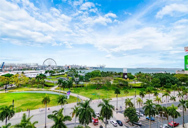 a view of a lake with houses in back