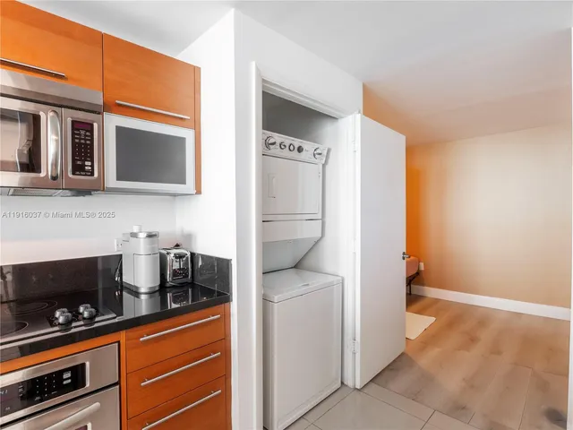 a kitchen with stainless steel appliances a refrigerator and cabinets