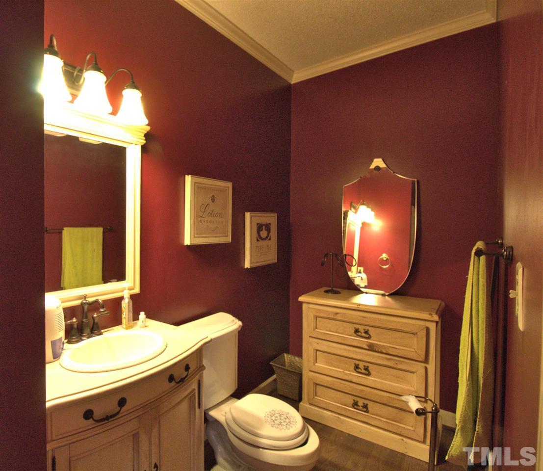 2407 Mt Vernon Church Road Raleigh, NC 27614 - Photo 8 of 29 a bathroom with a toilet sink vanity granite and mirror