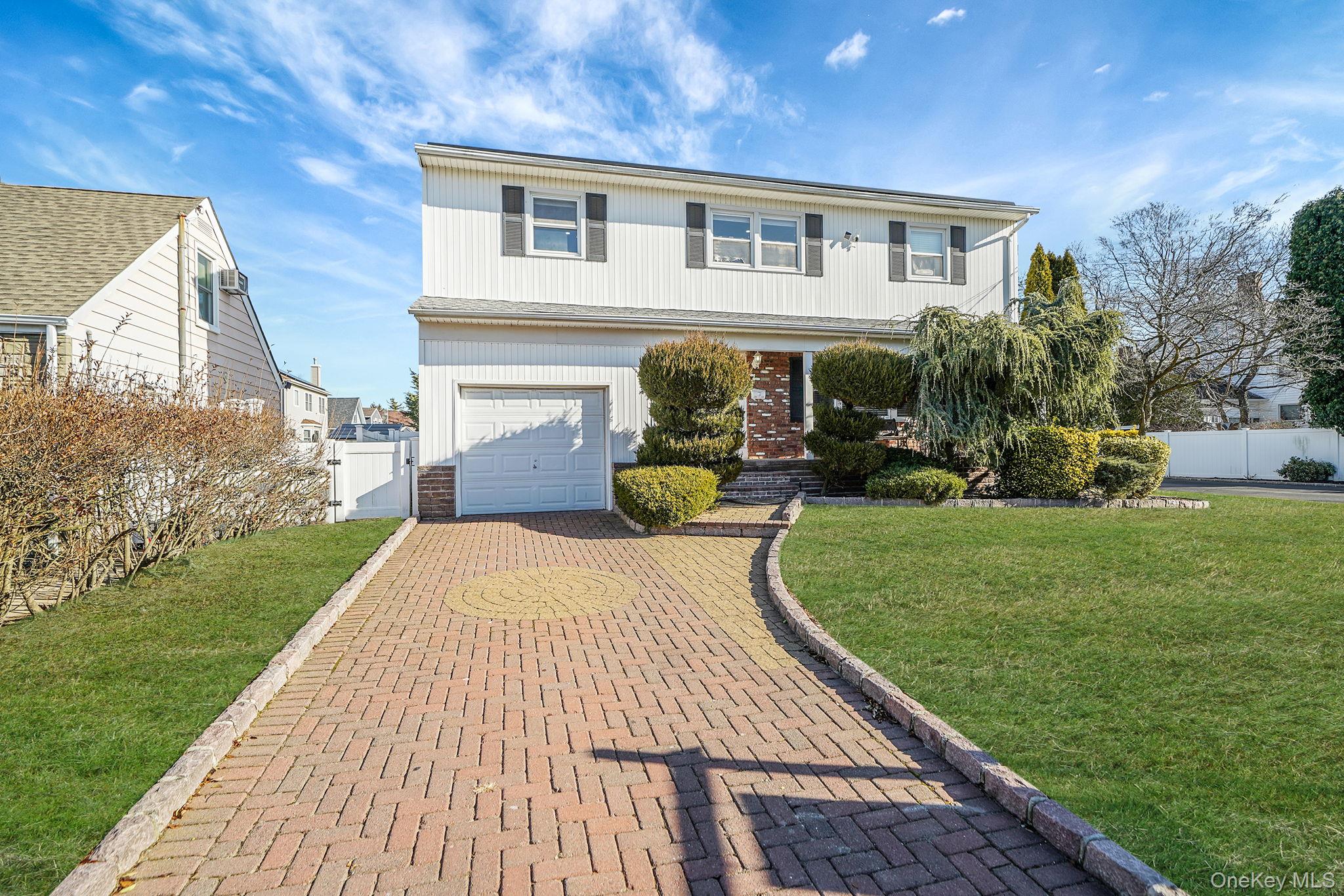 2415 Babylon Turnpike Merrick, NY 11566 - Photo 1 of 32 a front view of a house with a yard and potted plants