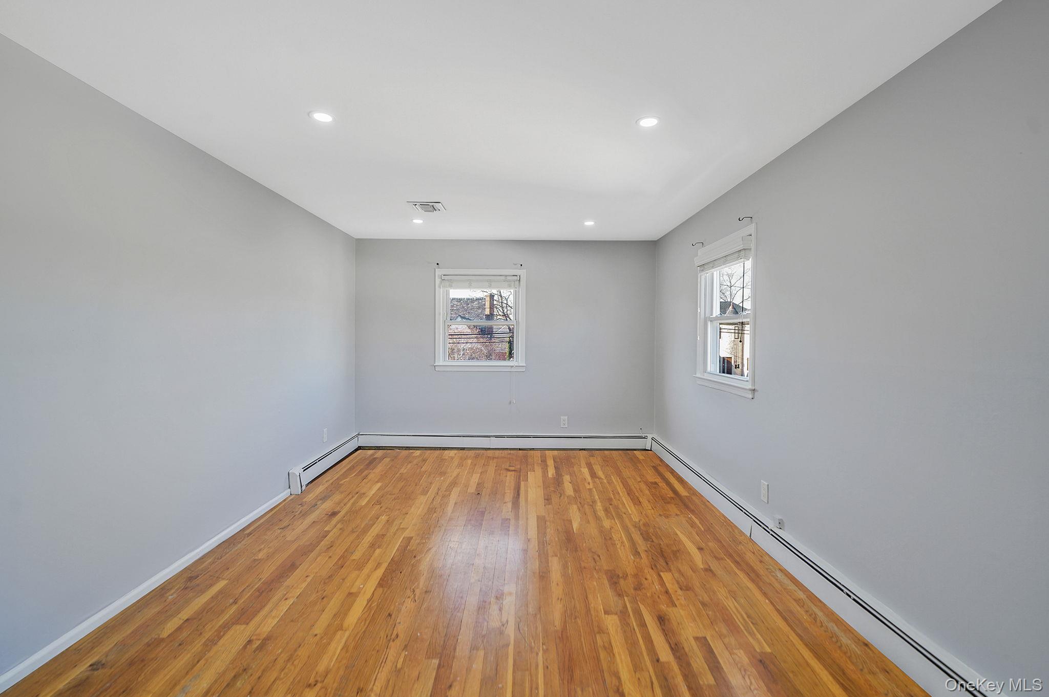 2415 Babylon Turnpike Merrick, NY 11566 - Photo 11 of 32 a view of room with window and wooden floor