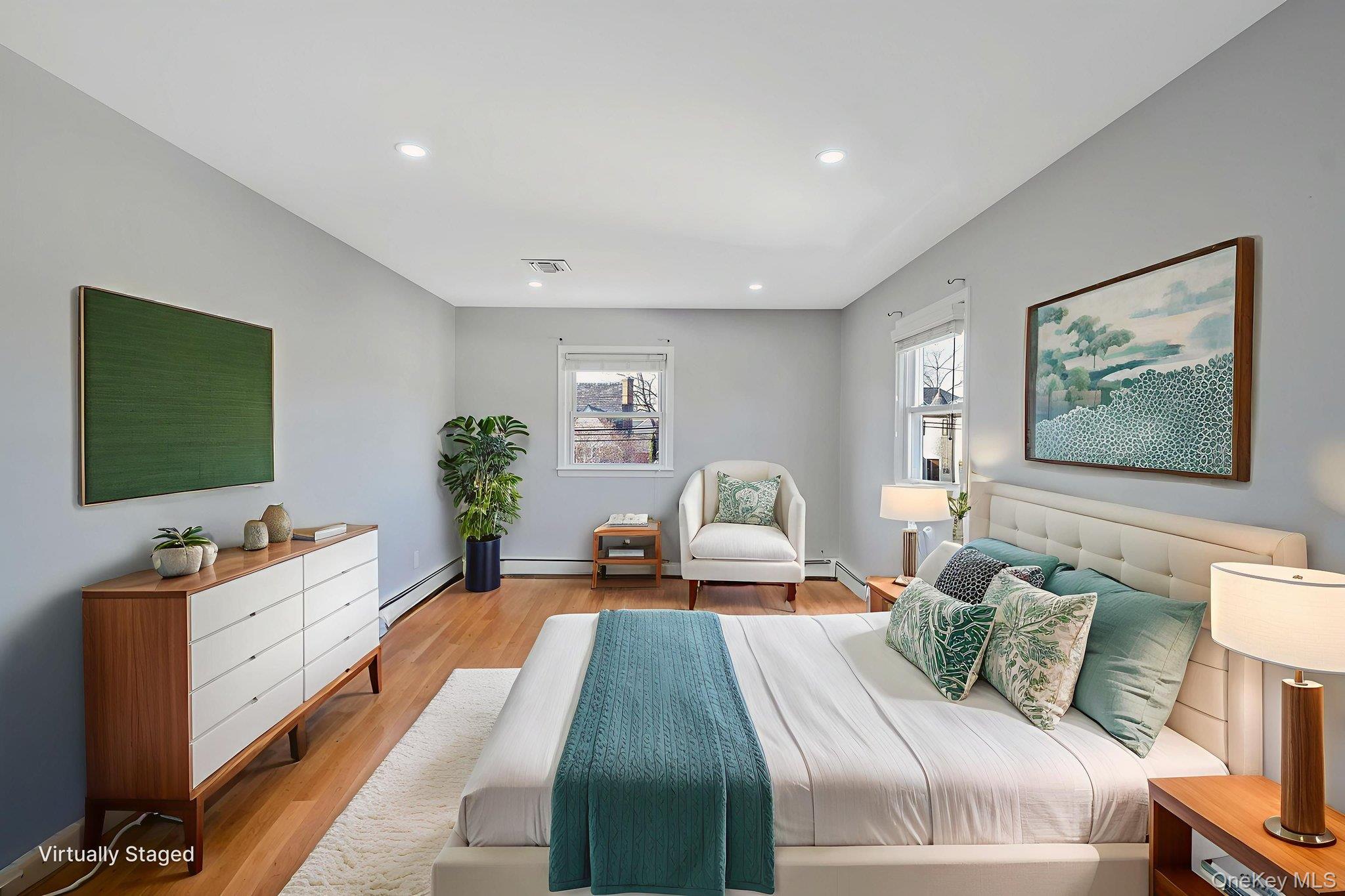 2415 Babylon Turnpike Merrick, NY 11566 - Photo 12 of 32 a bedroom with a bed and a flat screen tv