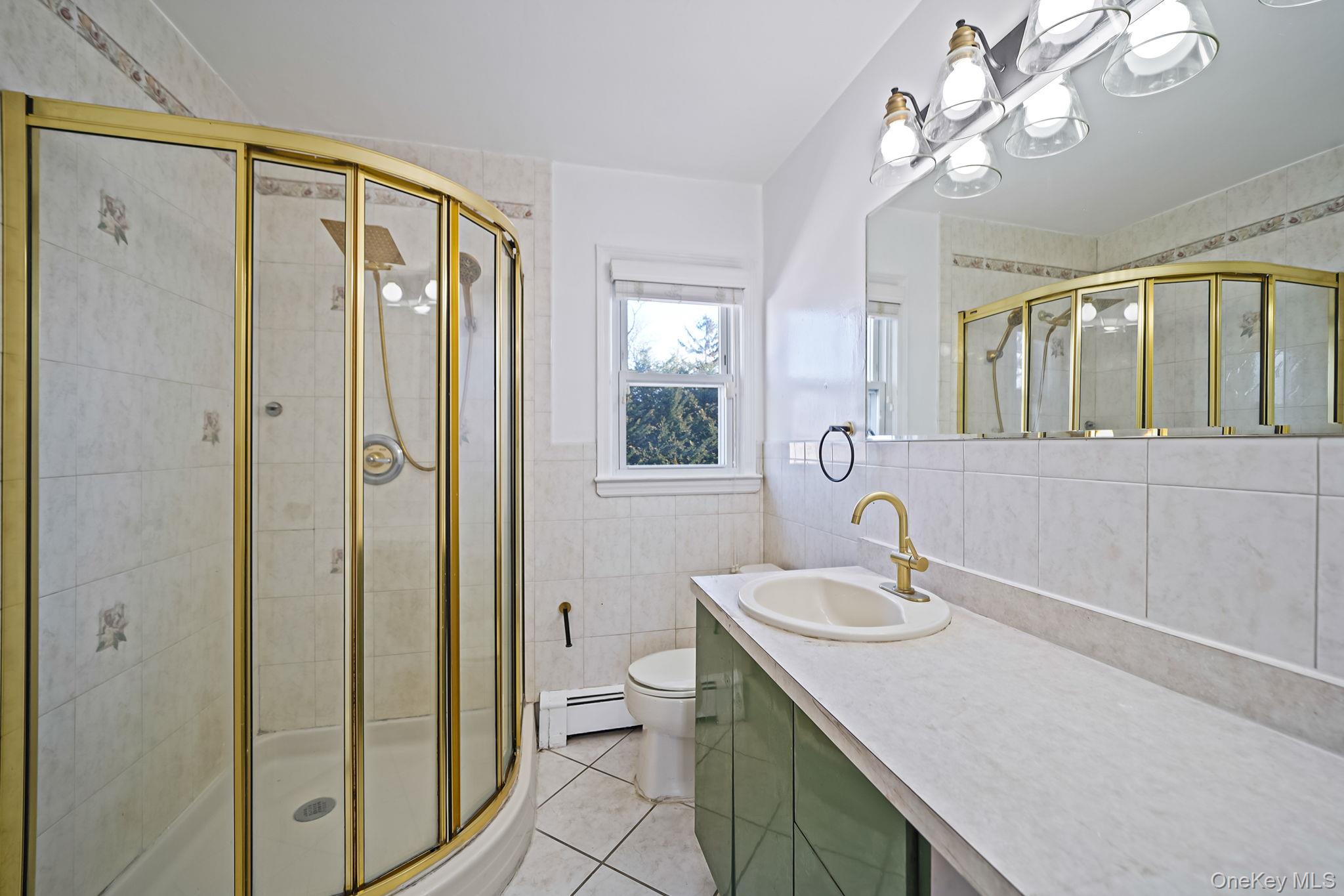 2415 Babylon Turnpike Merrick, NY 11566 - Photo 13 of 32 a bathroom with a sink a toilet and a mirror