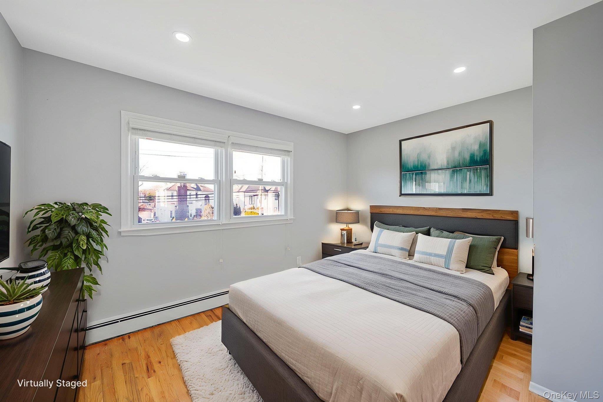 2415 Babylon Turnpike Merrick, NY 11566 - Photo 19 of 32 a bedroom with a bed and a painting on the wall