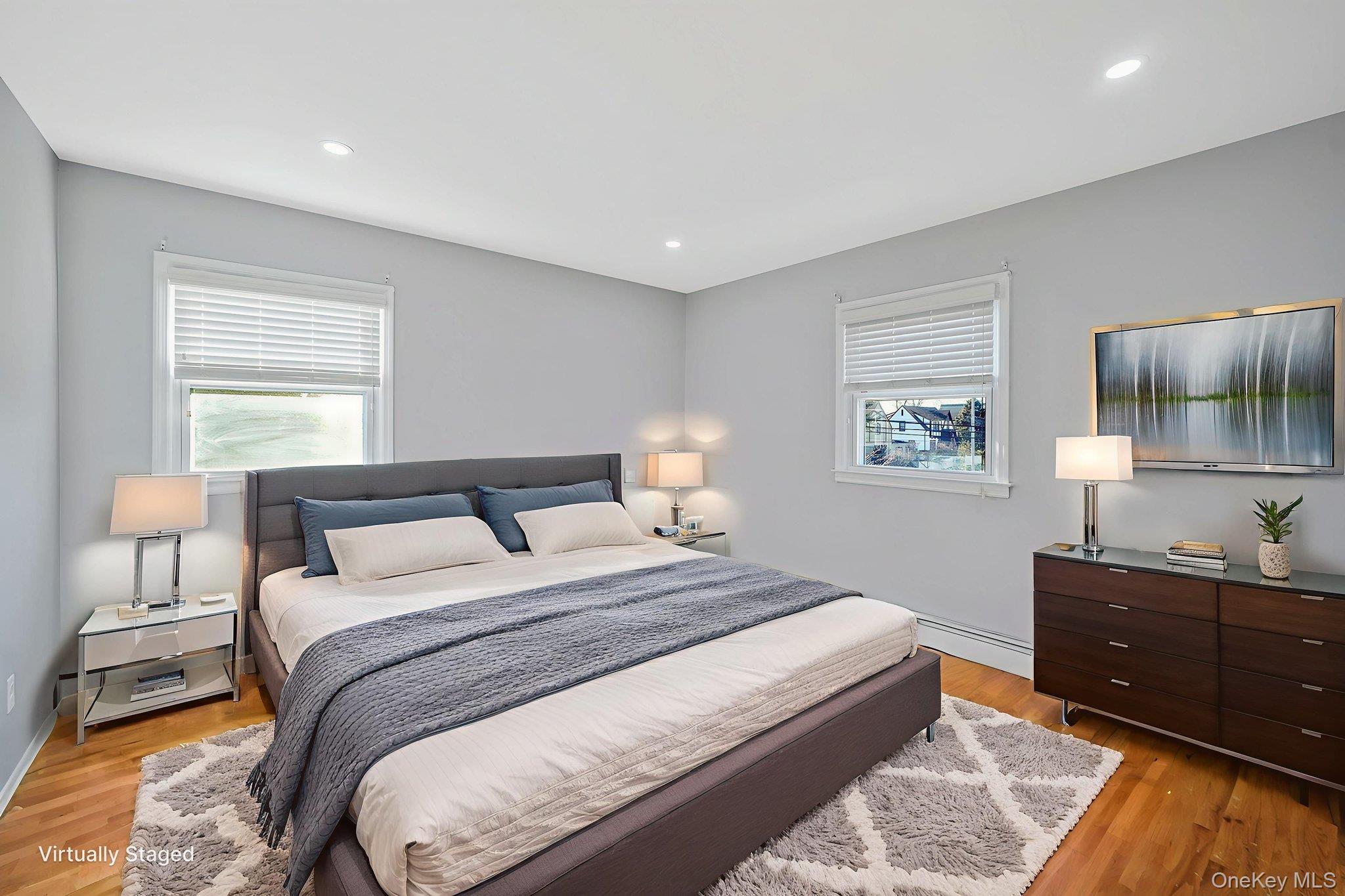 2415 Babylon Turnpike Merrick, NY 11566 - Photo 20 of 32 a bedroom with a bed and a lamp on dresser
