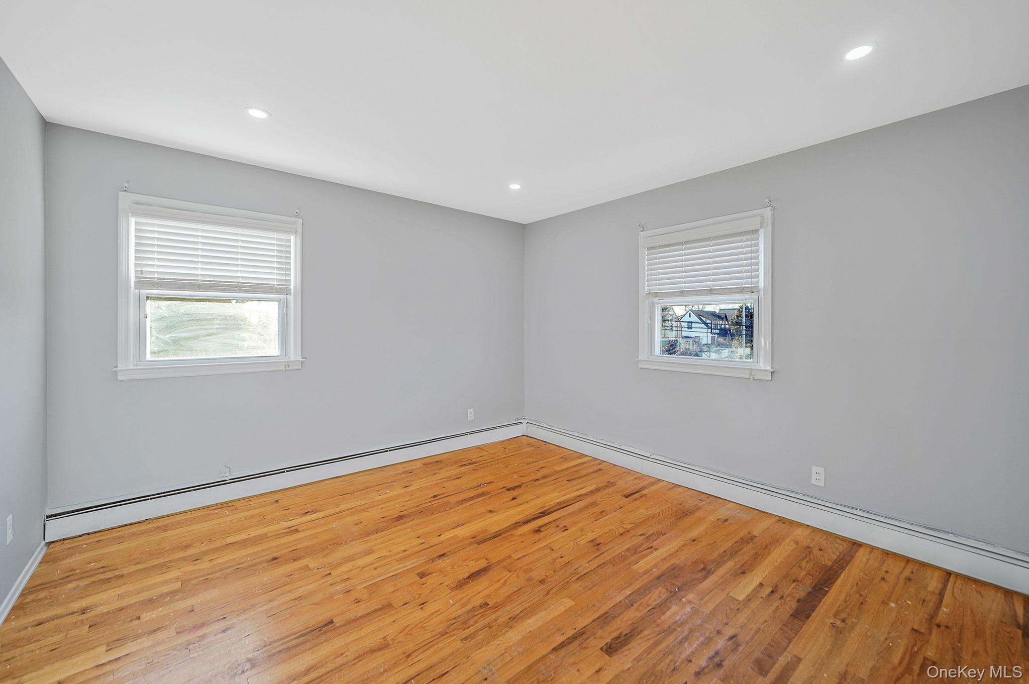 2415 Babylon Turnpike Merrick, NY 11566 - Photo 31 of 32 a view of empty room with wooden floor and fan
