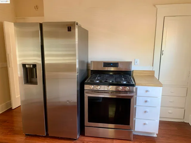 a kitchen with a stove and a refrigerator