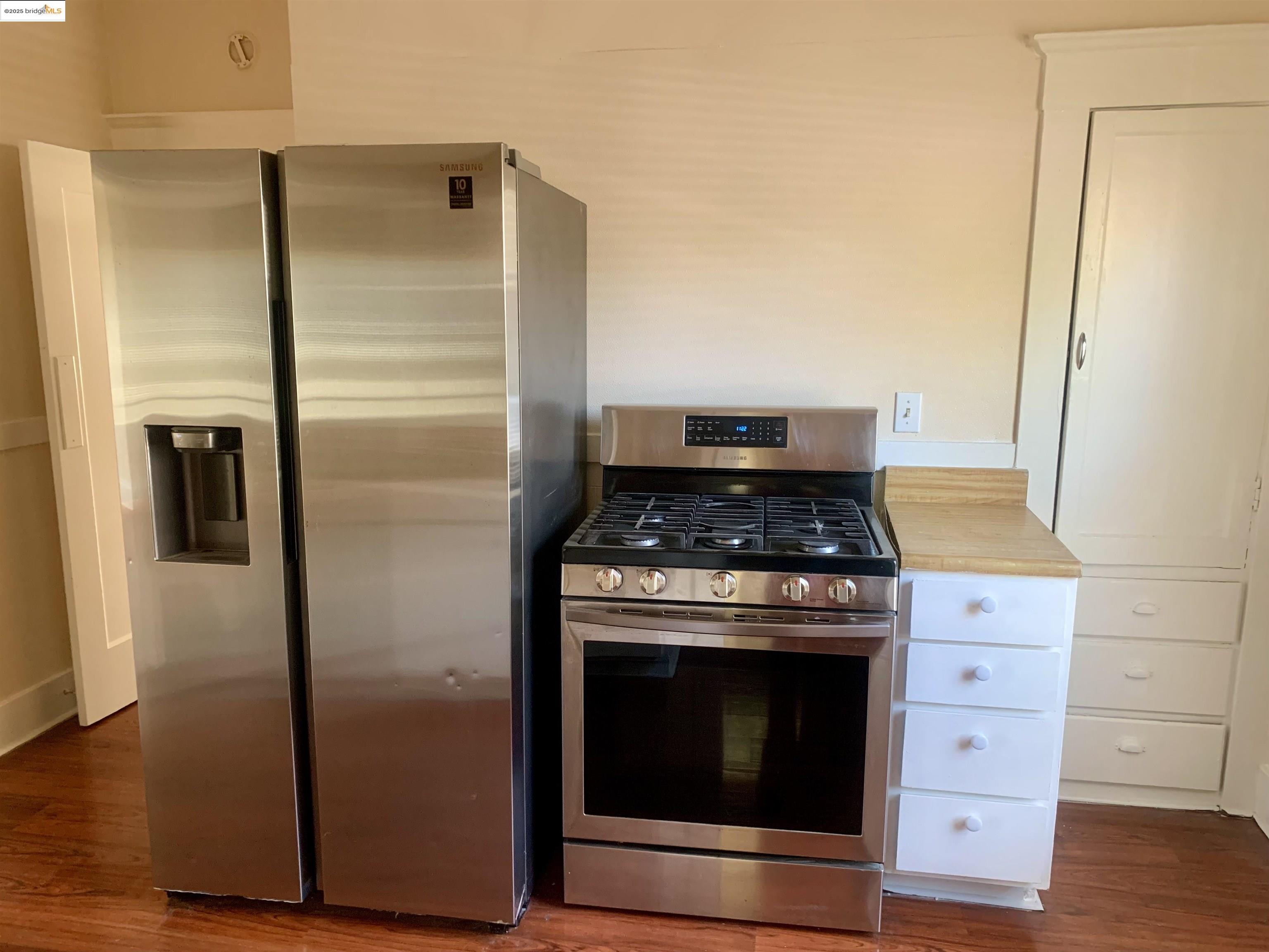 1028 61st Street Oakland, CA 94608 - Photo 14 of 28 a kitchen with a stove and a refrigerator