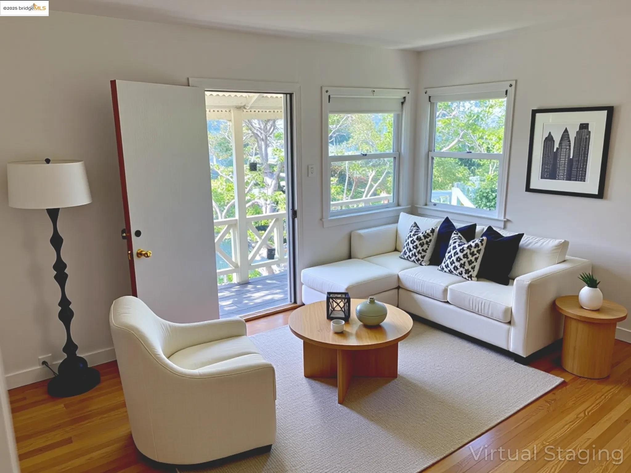 1028 61st Street Oakland, CA 94608 - Photo 19 of 28 a living room with furniture and a large window