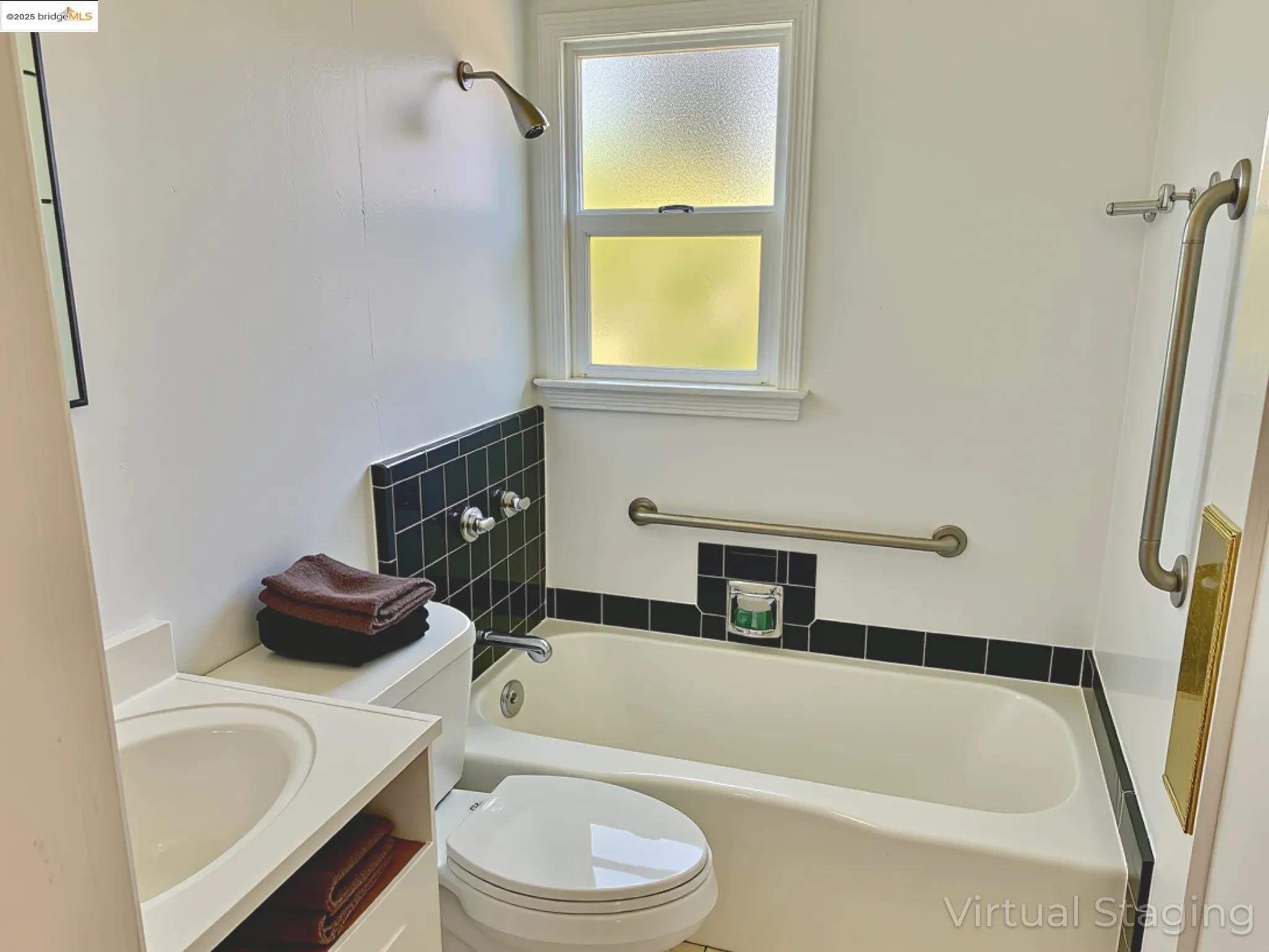 1028 61st Street Oakland, CA 94608 - Photo 21 of 28 a bathroom with a toilet sink and bathtub