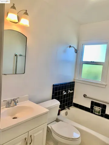 a bathroom with a sink a toilet and mirror